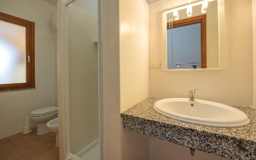 Modern bathroom with shower, sink, and toilet.